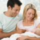 Couples at home with new baby. Consider these essential steps for updating your estate plan after welcoming a new baby as you enter this new chapter of your life.