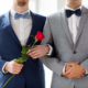 people, homosexuality, same-sex marriage and love concept - close up of happy male gay couple with red rose flower holding hands on wedding. LGBTQ+ Couples