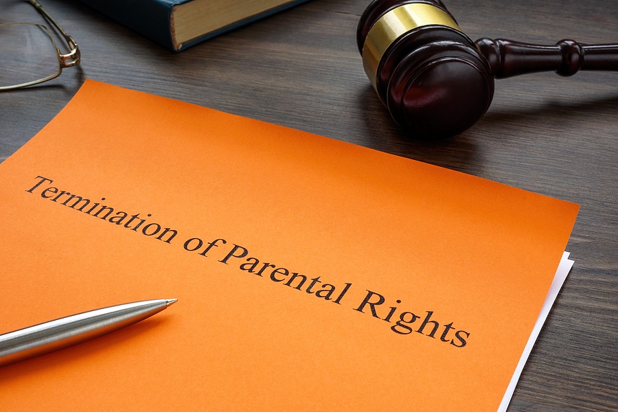 A legal document titled "Termination of Parental Rights" on a desk, symbolizing the formal process of ending a parent-child relationship.